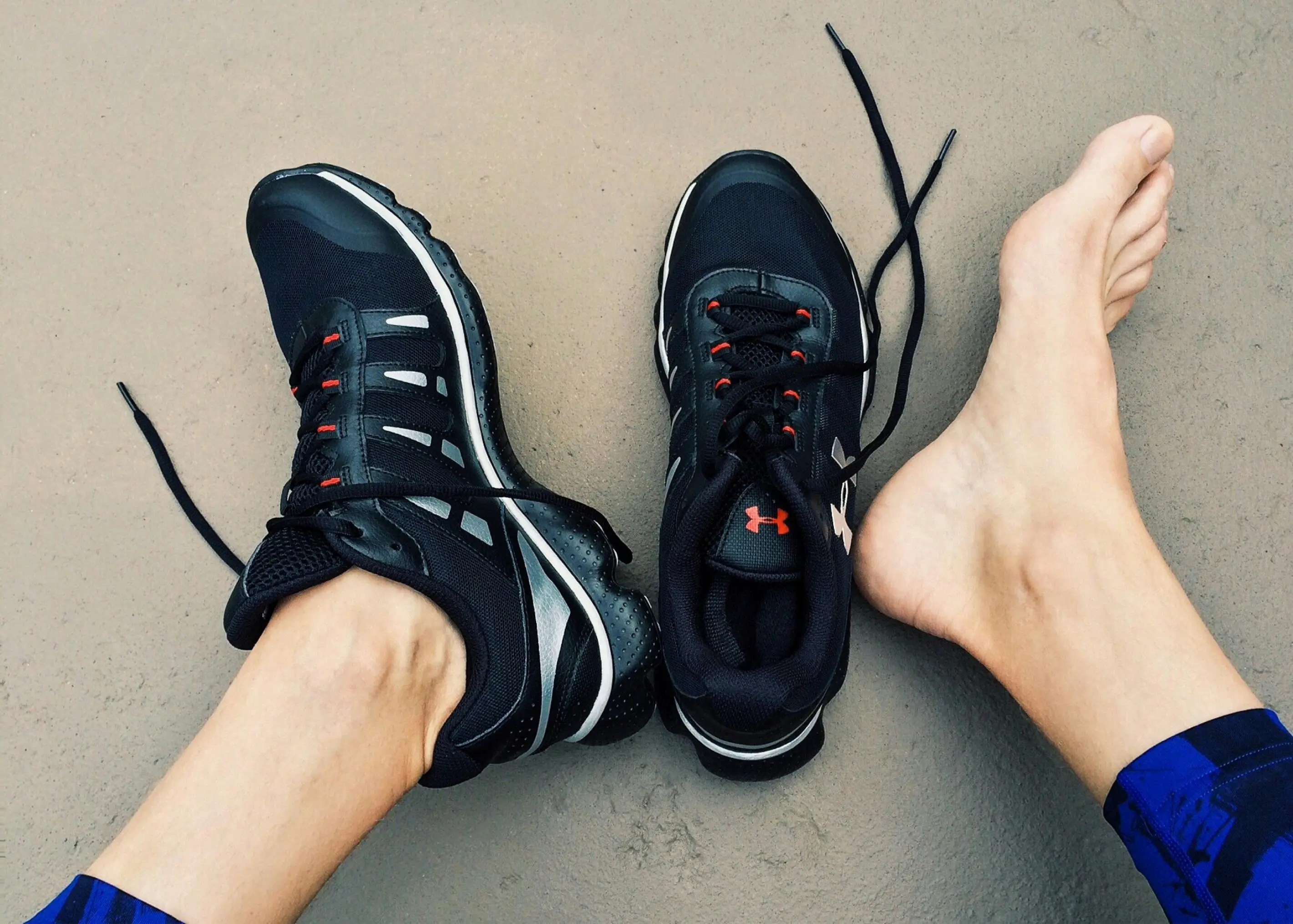 Close up of runner's feet with one shoe on and one shoe off